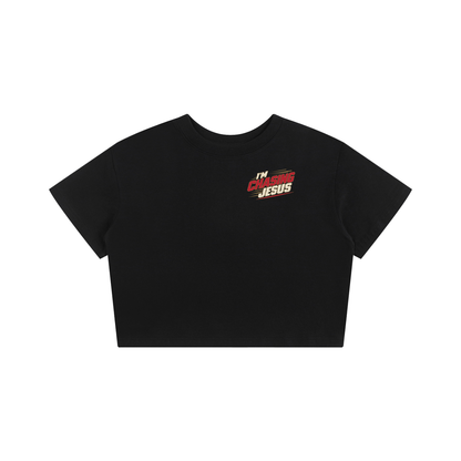 I'm Chasing Jesus Women's Baby Tee in Black, front view with the left chest graphic